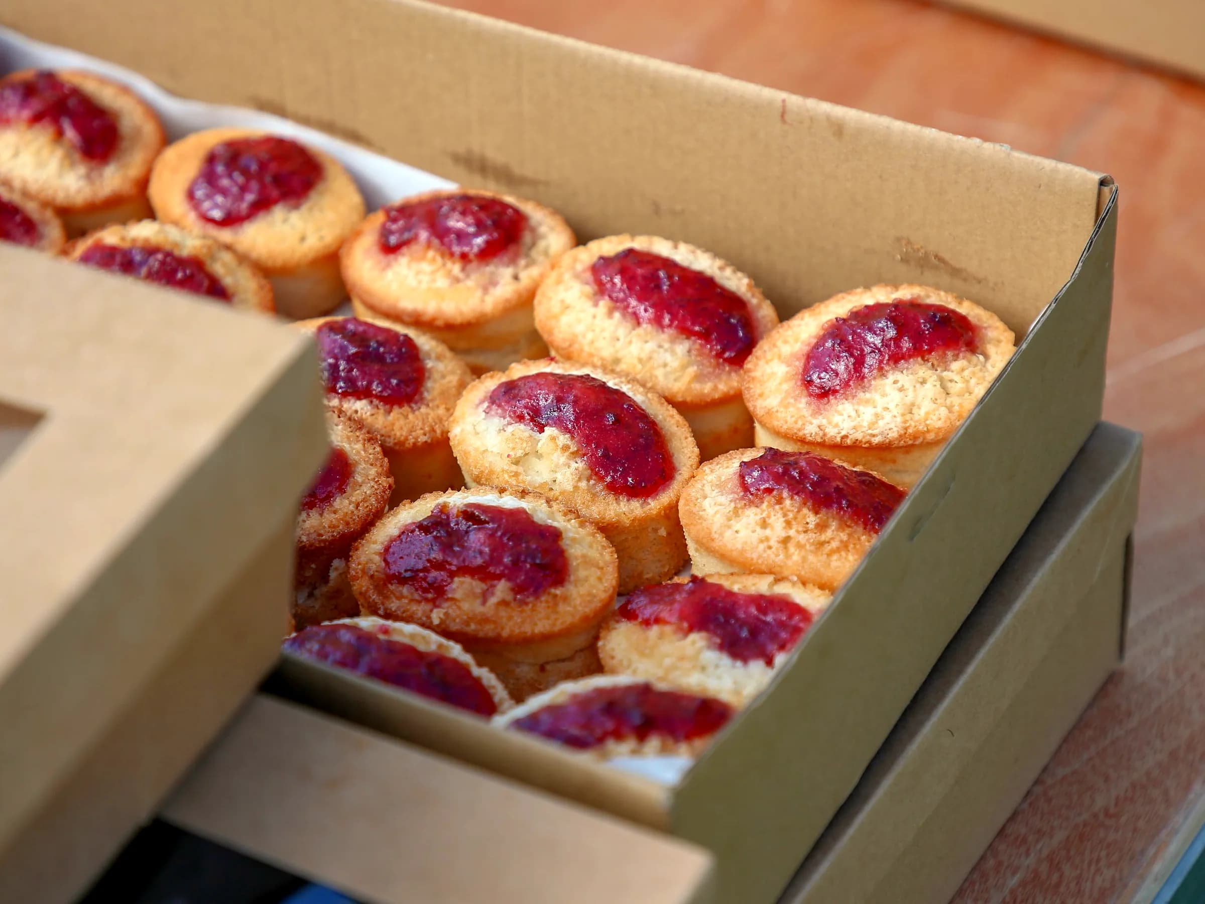 Jam-filled pastries packed in kraft paperboard bakery boxes
