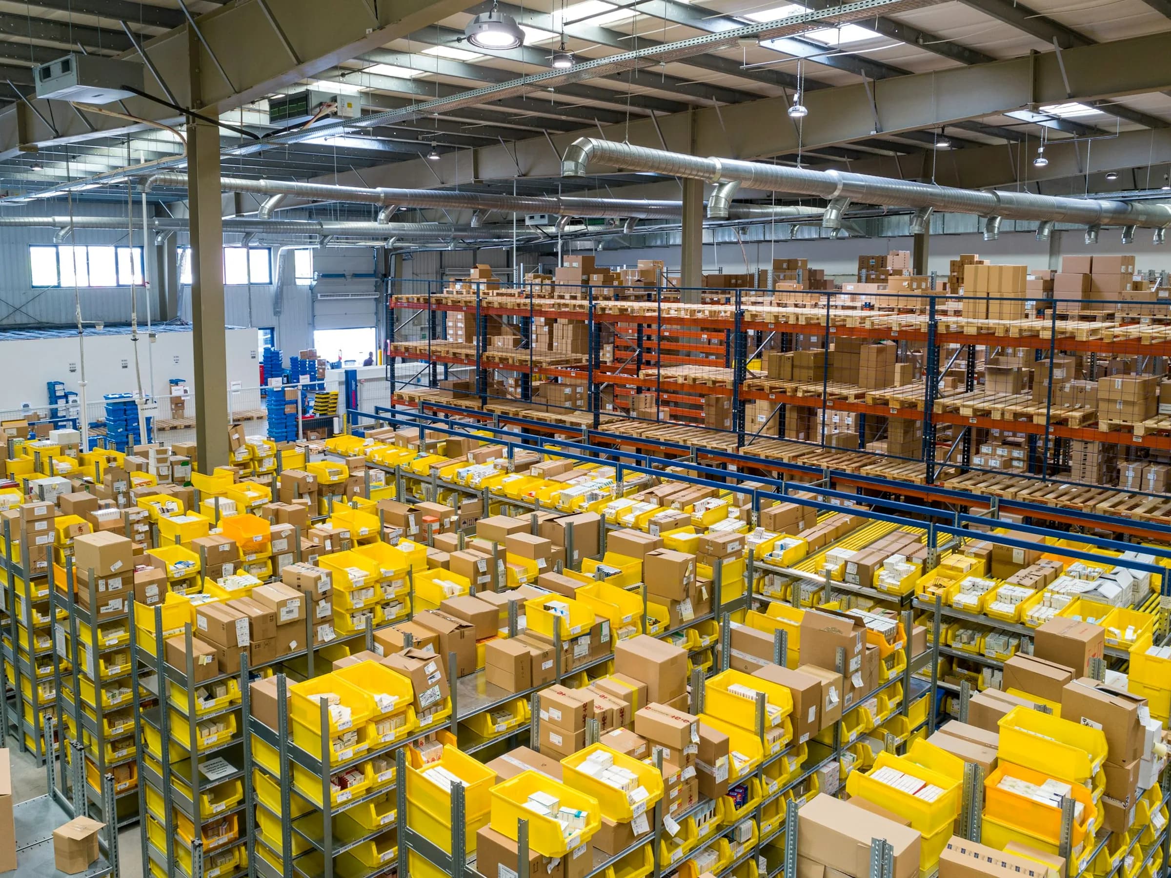 Industrial warehouse racks with corrugated cartons and component bins