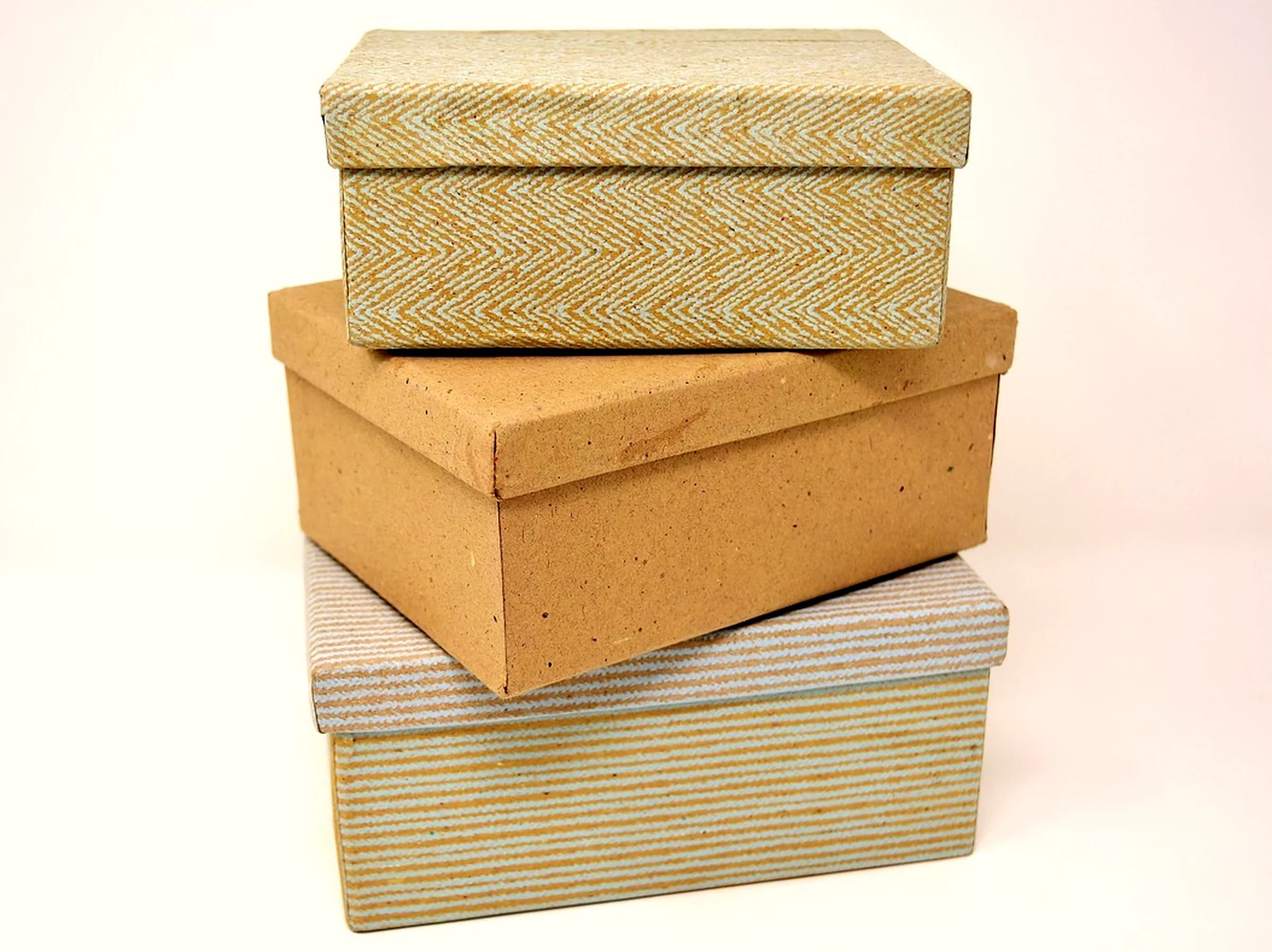 Stack of unbranded kraft and patterned paperboard folding cartons